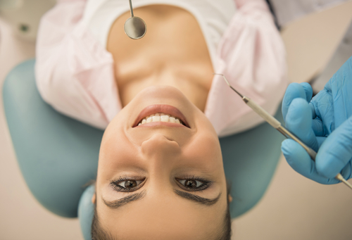 young lady in dental chair looking up