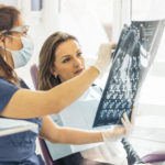 woman and dentist examine x-ray