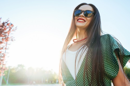 woman smiles in the sunlight